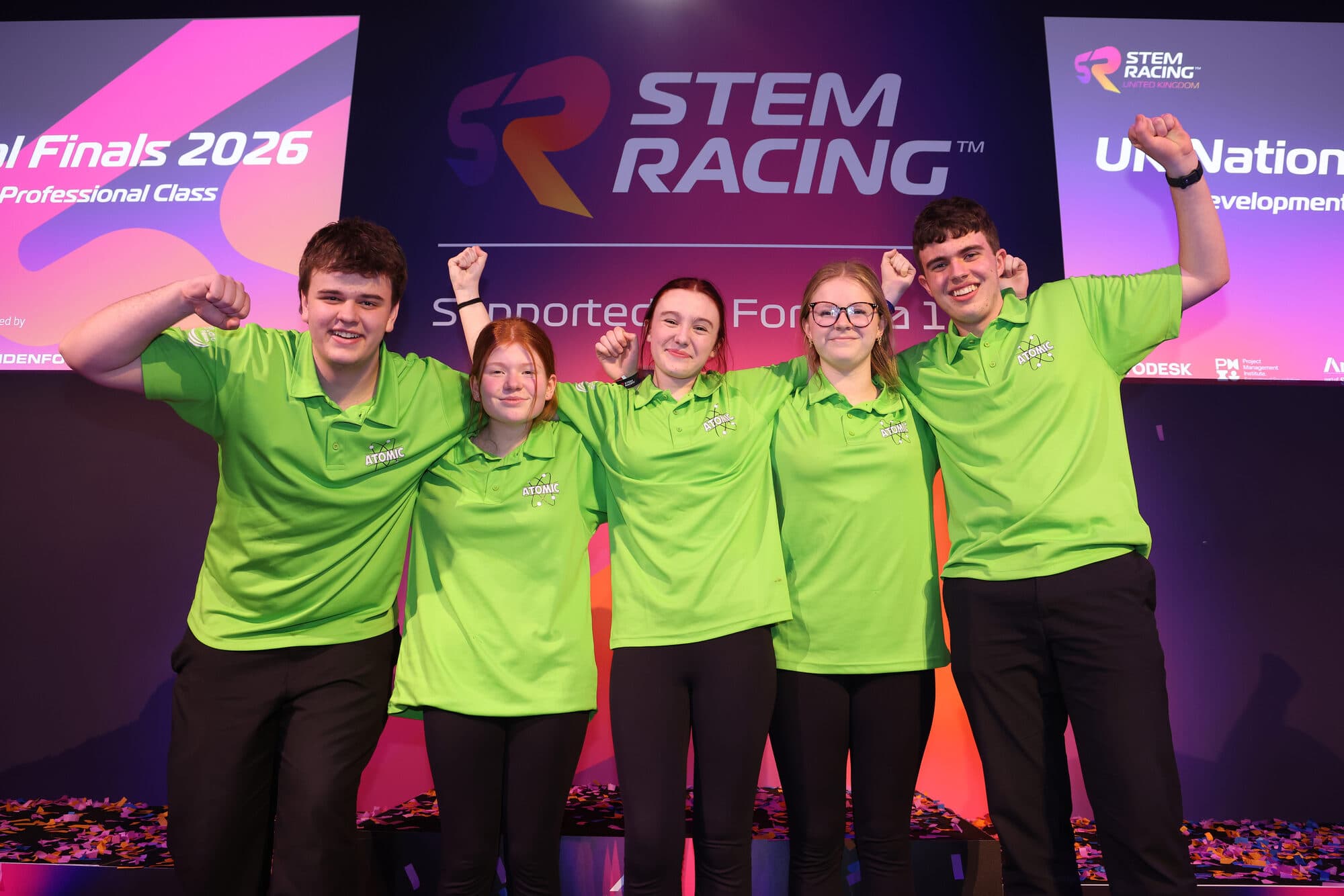 Team ATOMIC celebrating on stage after being crowned UK National Champions